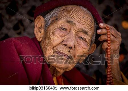 Stock Photography - "Female Buddhist monk, Boudhanath, Kathmandu, Kathmandu District, Bagmati Zone, Nepal, Asia". Fotosearch