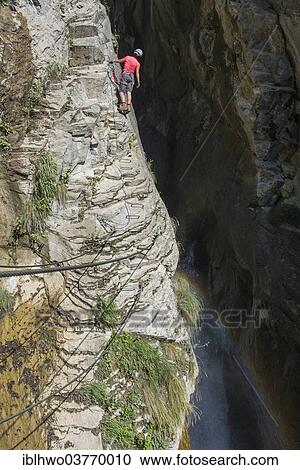 "Female climber on the fixed rope route """"Via Farinetta"""", gorge with waterfall, Leytron, Martigny, Canton of Valais, Switzerland, Europe" View Large Photo Image Stock Image - "Female climber on the fixed rope route """"Via Farinetta"""", gorge with waterfall, Leytron, Martigny, Canton of Valais, Switzerland, Europe". Fotosearch