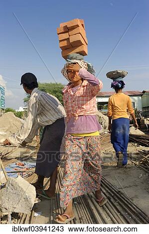 "Female construction workers carry bricks on their heads, high rise construction site, Mandalay, Myanmar, Asia" View Large Photo Image Stock Image - "Female construction workers carry bricks on their heads, high rise construction site, Mandalay, Myanmar, Asia". Fotosearch