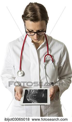 "Female doctor holding a tablet computer, iPad, with the MRI scan of a spine" View Large Photo Image Stock Photo - "Female doctor holding a tablet computer, iPad, with the MRI scan of a spine". Fotosearch
