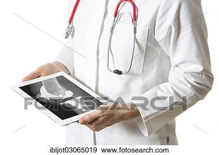 "Female doctor holding a tablet computer, iPad, with the X-ray of an artificial knee joint" View Large Photo Image Stock Photo - "Female doctor holding a tablet computer, iPad, with the X-ray of an artificial knee joint". Fotosearch