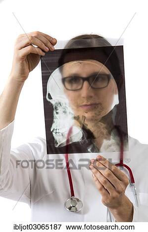 "Female doctor looking at an X-ray, head with neck and spine" View Large Photo Image Stock Photo - "Female doctor looking at an X-ray, head with neck and spine". Fotosearch