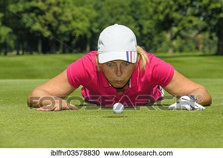 "Female golfer blowing a golf ball into the hole, Golfclub Schloss Myllendonk, Korschenbroich, North Rhine-Westphalia, Germany, Europe" View Large Photo Image Stock Image - "Female golfer blowing a golf ball into the hole, Golfclub Schloss Myllendonk, Korschenbroich, North Rhine-Westphalia, Germany, Europe". Fotosearch