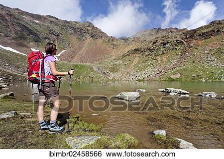 "Female hiker at Schwarzsee lake, Ulten Valley, Alto Adige, Italy, Europe" View Large Photo Image Stock Photograph - "Female hiker at Schwarzsee lake, Ulten Valley, Alto Adige, Italy, Europe". Fotosearch