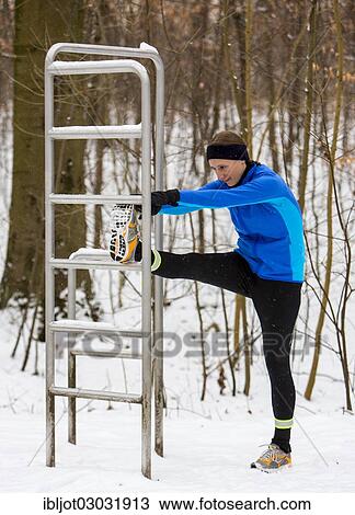 Female jogger doing stretching exercises before a run in a wintry forest View Large Photo Image Stock Image - Female jogger doing stretching exercises before a run in a wintry forest. Fotosearch