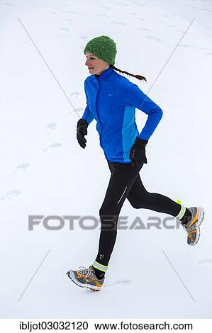 Female jogger on a run in winter in the snow View Large Photo Image Stock Image - Female jogger on a run in winter in the snow. Fotosearch
