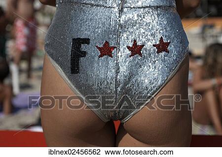 "Female member of a promotional team from one of the big clubs with advertising slogan on her bikini bottoms, at the Sa Trinxa-Beach restaurant, Playa de Ses Salines, Ibiza, Pine Islands, Balearic Islands, Spain, Europe" View Large Photo Image Stock Image - "Female member of a promotional team from one of the big clubs with advertising slogan on her bikini bottoms, at the Sa Trinxa-Beach restaurant, Playa de Ses Salines, Ibiza, Pine Islands, Balearic Islands, Spain, Europe". Fotosearch