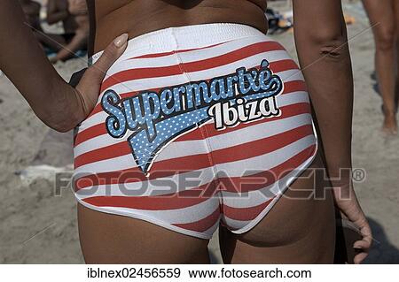 "Female member of a promotional team from one of the big clubs adverting the club """"Supermartxe"""" on her bikini bottoms, at the Sa Trinxa-Beach restaurant, Playa de Ses Salines, Ibiza, Pine Islands, Balearic Islands, Spain, Europe" View Large Photo Image Stock Photo - "Female member of a promotional team from one of the big clubs adverting the club """"Supermartxe"""" on her bikini bottoms, at the Sa Trinxa-Beach restaurant, Playa de Ses Salines, Ibiza, Pine Islands, Balearic Islands, Spain, Europe". Fotosearch