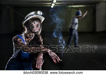 "Female mine worker holding a cigarette, Innsbruck, Tyrol, Austria, Europe" View Large Photo Image Stock Photo - "Female mine worker holding a cigarette, Innsbruck, Tyrol, Austria, Europe". Fotosearch