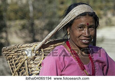 Picture - "Female Nepalese farmer carrying a basket, portrait, near Panauti, Nepal, Asia". Fotosearch