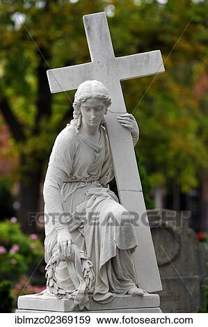"Female sculpture holding a wreath and a cross on a tomb, St. John's Cemetery, Brueckenstrasse 9, Nuremberg, Middle Franconia, Bavaria, Germany, Europe" View Large Photo Image Stock Photo - "Female sculpture holding a wreath and a cross on a tomb, St. John's Cemetery, Brueckenstrasse 9, Nuremberg, Middle Franconia, Bavaria, Germany, Europe". Fotosearch