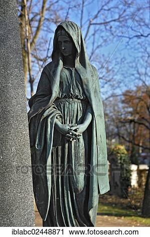 Stock Image - "Female sculpture on grave, Ostfriedhof, East Cemetery, Munich, Bavaria, Germany, Europe". Fotosearch