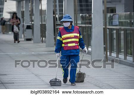 "Female street cleaner wearing a safety vest, mask and holding a sweeping tool, Shanghai, China, Asia" View Large Photo Image Picture - "Female street cleaner wearing a safety vest, mask and holding a sweeping tool, Shanghai, China, Asia". Fotosearch