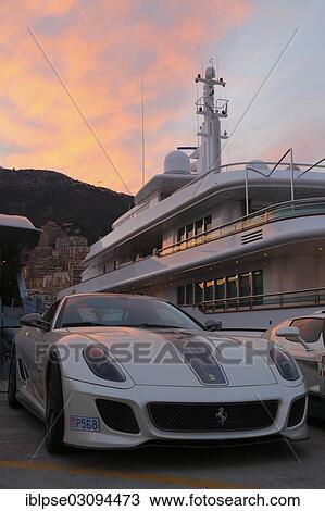 "Ferrari in front of the motoryacht """"Siran"""" in Port Hercule at twilight, Furstentum Monaco, Monaco, Monaco, Europe" View Large Photo Image Stock Image - "Ferrari in front of the motoryacht """"Siran"""" in Port Hercule at twilight, Furstentum Monaco, Monaco, Monaco, Europe". Fotosearch