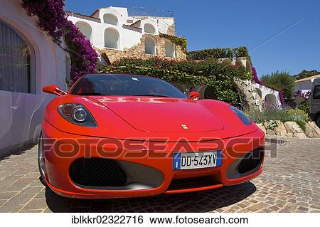 Stock Photograph - "Ferrari parked near the luxury marina in Poltu Quato, Costa Smeralda, Sardinia, Italy, Europe". Fotosearch