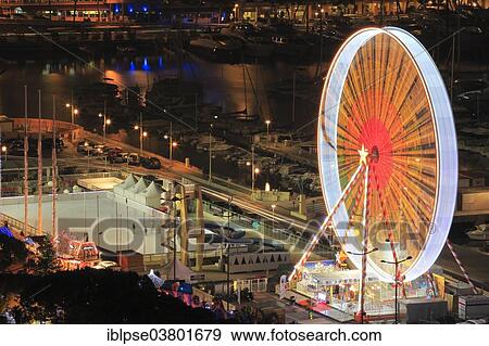 "Ferris wheel and ice rink at Port Hercule, behind Hotel Hermitage Monte-Carlo, Monaco, Mediterranean, Europe" View Large Photo Image Stock Photo - "Ferris wheel and ice rink at Port Hercule, behind Hotel Hermitage Monte-Carlo, Monaco, Mediterranean, Europe". Fotosearch