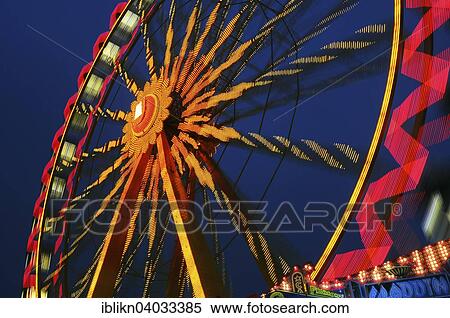 "Ferris wheel at dusk, blue hour, Hamburger Dom funfair, Hamburg, Germany, Europe" View Large Photo Image Stock Photography - "Ferris wheel at dusk, blue hour, Hamburger Dom funfair, Hamburg, Germany, Europe". Fotosearch