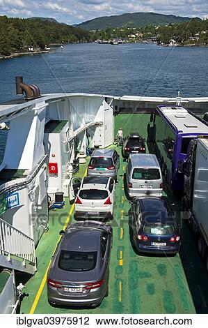 Stock Image - "Ferry carrying vehicles approaching the ferry port of Halhjem, Hordaland, Norway, Europe". Fotosearch