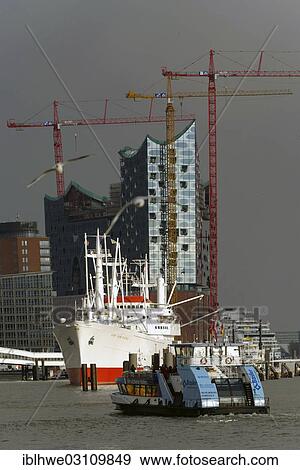 "Ferry crossing the canal in front of the Cap San Diego and the Elbe Philharmonic Hall, Hamburg, Hamburg, Hamburg, Germany, Europe" View Large Photo Image Stock Photo - "Ferry crossing the canal in front of the Cap San Diego and the Elbe Philharmonic Hall, Hamburg, Hamburg, Hamburg, Germany, Europe". Fotosearch