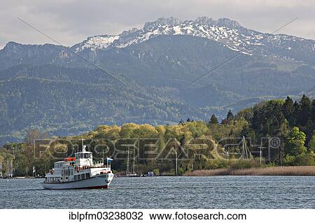 "Ferry on lake Chiemsee, Kampenwand mountain at the back, Chiemsee, Chiemgau, Upper Bavaria, Bavaria, Germany, Europe" View Large Photo Image Stock Image - "Ferry on lake Chiemsee, Kampenwand mountain at the back, Chiemsee, Chiemgau, Upper Bavaria, Bavaria, Germany, Europe". Fotosearch