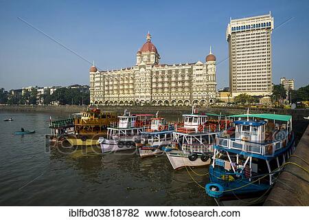 Stock Image - "Ferryboats anchoring in the harbour in front of Taj Mahal Palace Hotel, Colaba, Mumbai, Maharashtra, India, Asia". Fotosearch