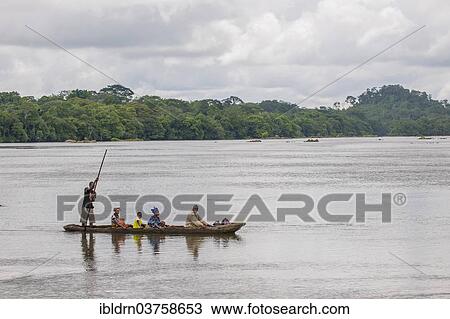 "Ferryman taking passengers across the Moa River in a pirogue, Tiwai Island Wildlife Sanctuary, Tiwai Island, Southern Province, Sierra Leone, Africa" View Large Photo Image Stock Image - "Ferryman taking passengers across the Moa River in a pirogue, Tiwai Island Wildlife Sanctuary, Tiwai Island, Southern Province, Sierra Leone, Africa". Fotosearch