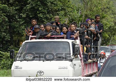 Stock Image - "Festival of the Dead, many people travelling on a truck, Rantepao, South Sulawesi, Indonesia, Asia". Fotosearch