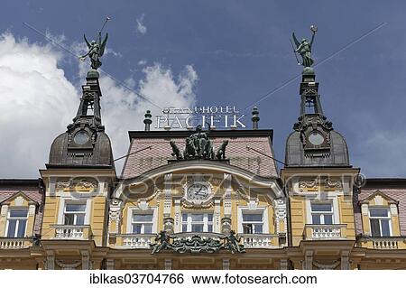 "Figurative decoration and a clock, historic facade, Grand Hotel Pacifik, Marianske Lazne, Karlovy Vary Region, Bohemia, Czech Republic, Europe" View Large Photo Image Stock Photograph - "Figurative decoration and a clock, historic facade, Grand Hotel Pacifik, Marianske Lazne, Karlovy Vary Region, Bohemia, Czech Republic, Europe". Fotosearch