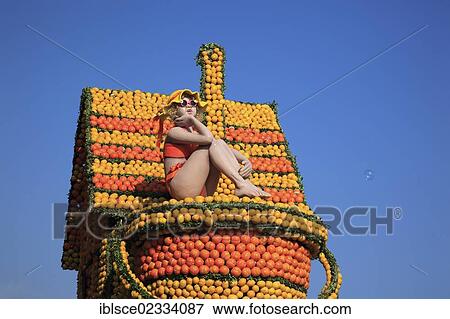 "Figure of a woman, doll, on a float made of citrus fruits during a parade, Lemon Festival, Fete du Citron, Menton, France, Europe" View Large Photo Image Stock Photo - "Figure of a woman, doll, on a float made of citrus fruits during a parade, Lemon Festival, Fete du Citron, Menton, France, Europe". Fotosearch