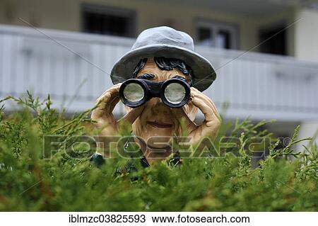 "Figure with a hat and binoculars looking over a hedge, Weitnau, Bavaria, Germany, Europe" View Large Photo Image Stock Image - "Figure with a hat and binoculars looking over a hedge, Weitnau, Bavaria, Germany, Europe". Fotosearch