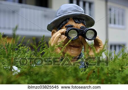 "Figure with a hat and binoculars looking over a hedge, Weitnau, Bavaria, Germany, Europe" View Large Photo Image Stock Photography - "Figure with a hat and binoculars looking over a hedge, Weitnau, Bavaria, Germany, Europe". Fotosearch