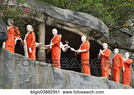 "Figures of Buddhist monks in front of a rock niche at the Golden Temple, Dambulla, Central Province, Sri Lanka, Asia" View Large Photo Image Stock Image - "Figures of Buddhist monks in front of a rock niche at the Golden Temple, Dambulla, Central Province, Sri Lanka, Asia". Fotosearch