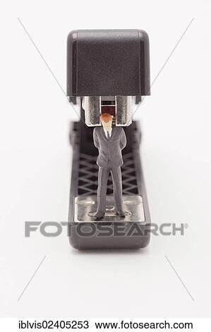 Figurine of businessman trapped by a stapler View Large Photo Image Stock Image - Figurine of businessman trapped by a stapler. Fotosearch