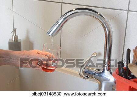 "Filling a glass with tap water in a kitchen, France, Europe" View Large Photo Image Stock Image - "Filling a glass with tap water in a kitchen, France, Europe". Fotosearch