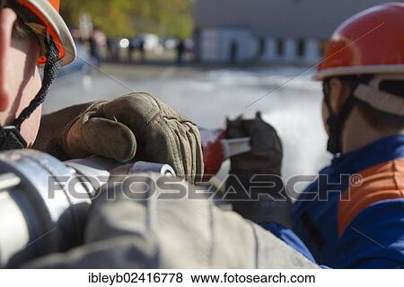 Stock Photo - Final fire service drill of the young Stuttgart firefighters in autumn, on the grounds of the Robert Bosch GmbH in Feuerbach, Stuttgart, Baden-Wuerttemberg, Germany, Europe. Fotosearch