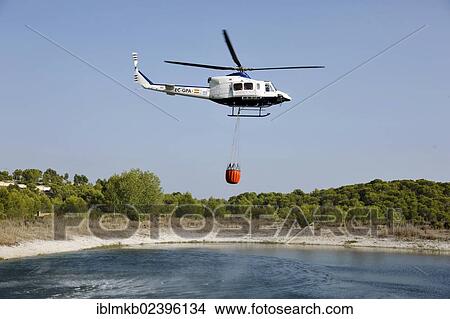 "Fire helicopter getting water from a small artificial lake near Altea La Vella, Costa Blanca, Alicante, Spain, Europe" View Large Photo Image Picture - "Fire helicopter getting water from a small artificial lake near Altea La Vella, Costa Blanca, Alicante, Spain, Europe". Fotosearch