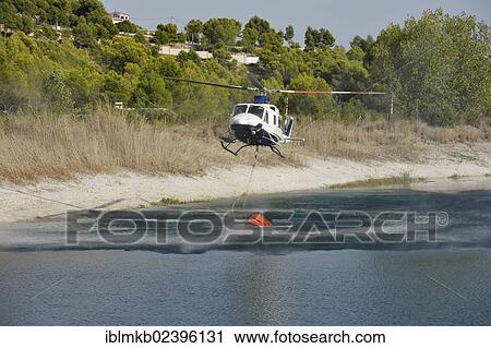 "Fire helicopter getting water from a small artificial lake near Altea La Vella, Costa Blanca, Alicante, Spain, Europe" View Large Photo Image Stock Image - "Fire helicopter getting water from a small artificial lake near Altea La Vella, Costa Blanca, Alicante, Spain, Europe". Fotosearch