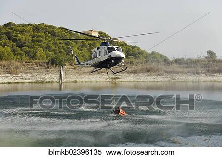 "Fire helicopter getting water from a small artificial lake near Altea La Vella, Costa Blanca, Alicante, Spain, Europe" View Large Photo Image Stock Photography - "Fire helicopter getting water from a small artificial lake near Altea La Vella, Costa Blanca, Alicante, Spain, Europe". Fotosearch