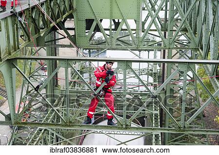 Stock Image - "Firefighter practicing rescue from heights on the old Henrichenburg boat lift, Waltrop, North Rhine-Westphalia, Germany, Europe". Fotosearch