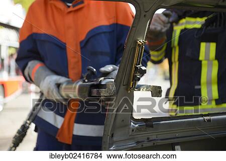 Firefighter working with hydraulic rescue equipment, final fire service drill of the young Stuttgart firefighters in autumn, Stuttgart, Baden-Wuerttemberg, Germany, Europe View Large Photo Image Picture - Firefighter working with hydraulic rescue equipment, final fire service drill of the young Stuttgart firefighters in autumn, Stuttgart, Baden-Wuerttemberg, Germany, Europe. Fotosearch