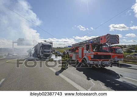 "Firefighters extinguishing a truck fire on the A8 motorway near the """"Echterdinger Ei"""" junction, Stuttgart, Baden-Wuerttemberg, Germany, Europe" View Large Photo Image Stock Image - "Firefighters extinguishing a truck fire on the A8 motorway near the """"Echterdinger Ei"""" junction, Stuttgart, Baden-Wuerttemberg, Germany, Europe". Fotosearch