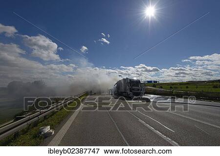 Stock Photo - "Firefighters extinguishing a truck fire on the A8 motorway near the """"Echterdinger Ei"""" junction, Stuttgart, Baden-Wuerttemberg, Germany, Europe". Fotosearch
