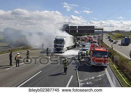 Stock Photography - "Firefighters extinguishing a truck fire on the A8 motorway near the """"Echterdinger Ei"""" junction, Stuttgart, Baden-Wuerttemberg, Germany, Europe". Fotosearch
