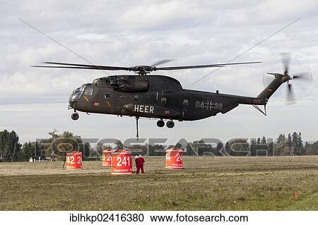 Firefighters hanging a 5000-liter water tank under a CH-53 helicopter of the German armed forces, during an exercise, Laupheim, Baden-Wuerttemberg, Germany, Europe View Large Photo Image Stock Image - Firefighters hanging a 5000-liter water tank under a CH-53 helicopter of the German armed forces, during an exercise, Laupheim, Baden-Wuerttemberg, Germany, Europe. Fotosearch