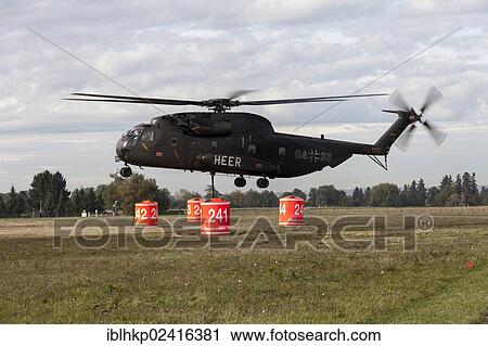 Firefighters hanging a 5000-liter water tank under a CH-53 helicopter of the German armed forces, during an exercise, Laupheim, Baden-Wuerttemberg, Germany, Europe View Large Photo Image Stock Image - Firefighters hanging a 5000-liter water tank under a CH-53 helicopter of the German armed forces, during an exercise, Laupheim, Baden-Wuerttemberg, Germany, Europe. Fotosearch