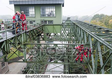 "Firefighters practicing rescue from heights on the old Henrichenburg boat lift, Waltrop, North Rhine-Westphalia, Germany, Europe" View Large Photo Image Stock Image - "Firefighters practicing rescue from heights on the old Henrichenburg boat lift, Waltrop, North Rhine-Westphalia, Germany, Europe". Fotosearch