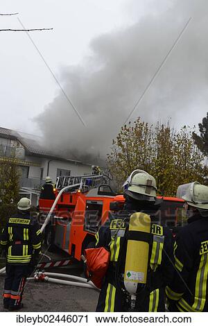 "Firefighters wearing breathing equipment while extinguishing a roof fire, Aichwald, Baden-Wurttemberg, Germany, Europe" View Large Photo Image Stock Image - "Firefighters wearing breathing equipment while extinguishing a roof fire, Aichwald, Baden-Wurttemberg, Germany, Europe". Fotosearch