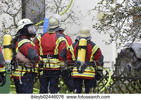 "Firefighters wearing breathing equipment while extinguishing a roof fire, Aichwald, Baden-Wurttemberg, Germany, Europe" View Large Photo Image Stock Photograph - "Firefighters wearing breathing equipment while extinguishing a roof fire, Aichwald, Baden-Wurttemberg, Germany, Europe". Fotosearch