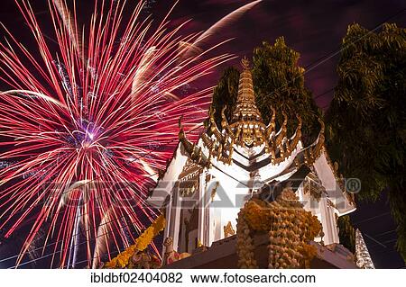 Stock Image - "Fireworks behind a Buddhist temple, Loi Krathong or Loy Gratong Festival, Chiang Mai, Northern Thailand, Thailand, Asia". Fotosearch