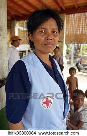 "First aid and community health worker wearing a vest of the Red Cross, Tropeng Village, Bathi District, Takeo Province, Cambodia, Asia" View Large Photo Image Picture - "First aid and community health worker wearing a vest of the Red Cross, Tropeng Village, Bathi District, Takeo Province, Cambodia, Asia". Fotosearch